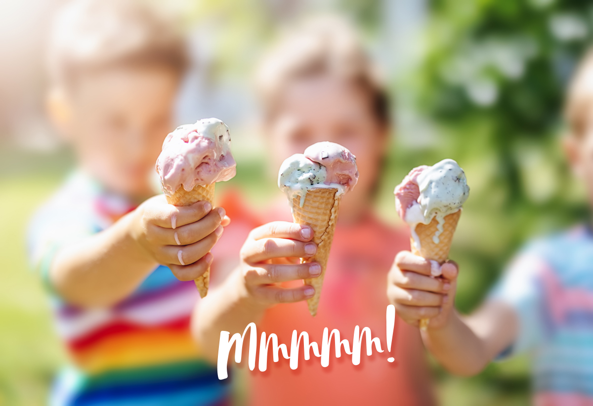 Group of children in the park eating cold ice cream. Ice Creamery in Bright